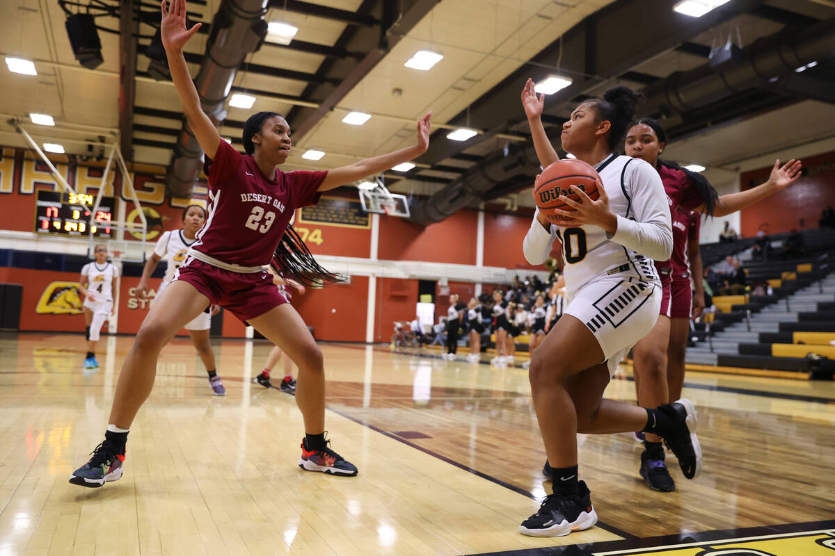Clark's Sarah Upshaw (4) dribbles the ball to the basket under pressure from Desert Oasis' Madi ...