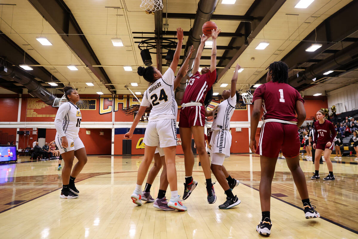 Desert Oasis' Madison Pescado (23) takes a shot at the basket under pressure from Clark's Trini ...
