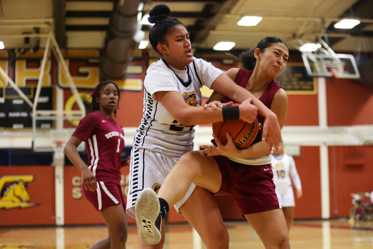 Desert Oasis' Jaylene Heeszel (2) fights for the ball against Clark's Trinity Tavita (24) durin ...