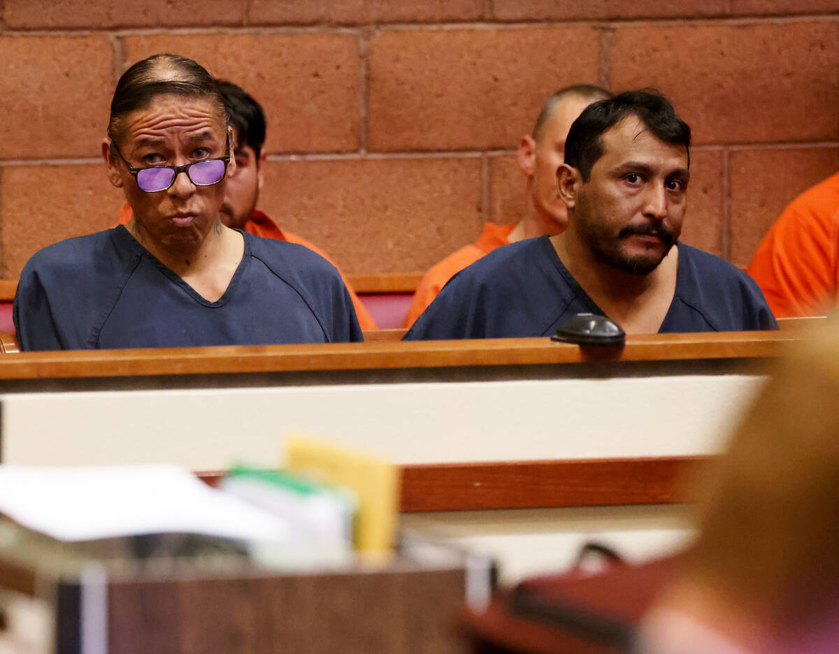 Nathan Chasing Horse, accused of raping and sex trafficking women and girls, left, waits during ...
