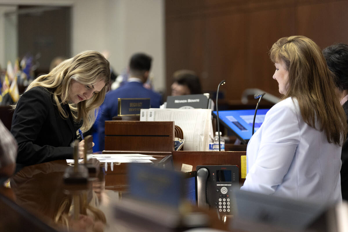 Sen. Melanie Scheible, D-Las Vegas, signs her oath of office during the first day of the 82nd S ...