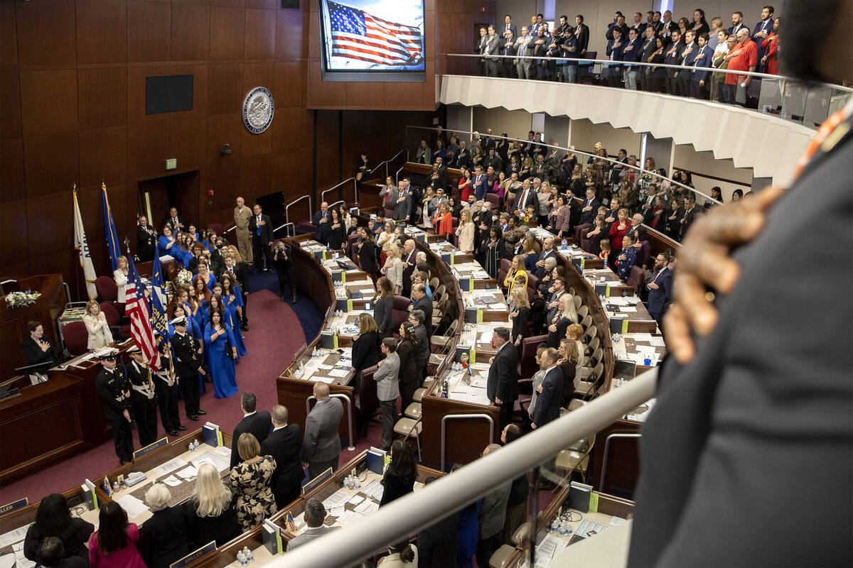Lawmakers stand for the pledge of allegiance as the Assembly convenes for the first day of the ...