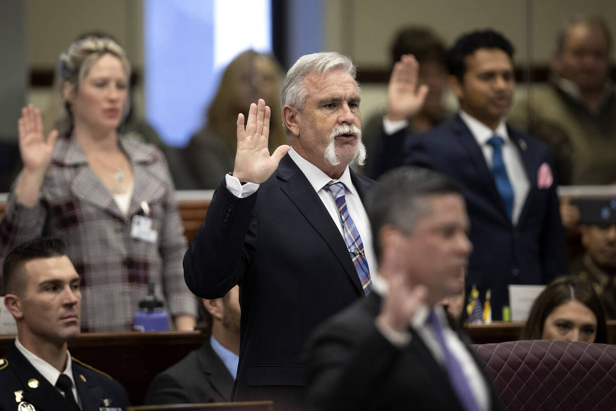Assemblyman Max Carter, D-Las Vegas, swears in during the first day of the 82nd Session of the ...