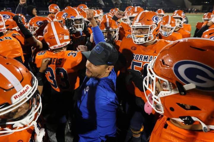 Bishop Gorman head coach Brent Browner huddles with players after defeating Desert Pines in a C ...