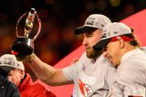 FILE - Kansas City Chiefs tight end Travis Kelce holds the Lamar Hunt Trophy while celebrating ...