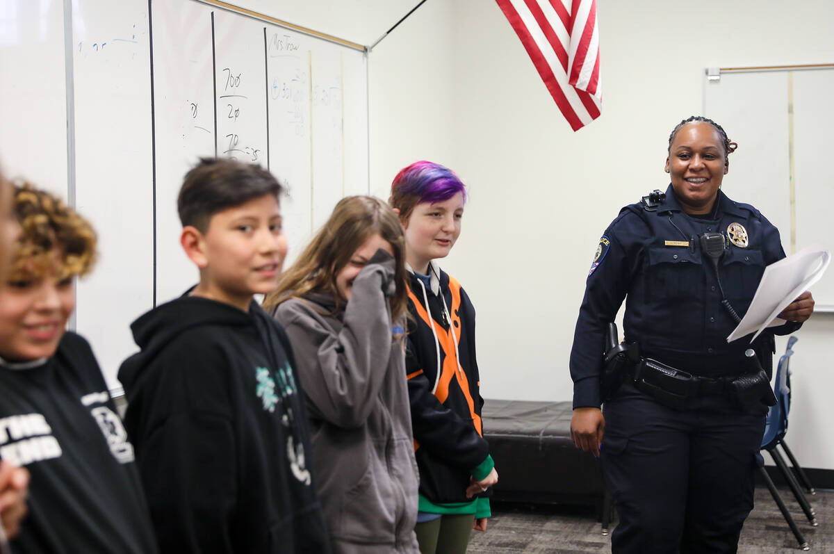 Clark County School District Police Officer Artesia Henry laughs with kids as she leads a class ...
