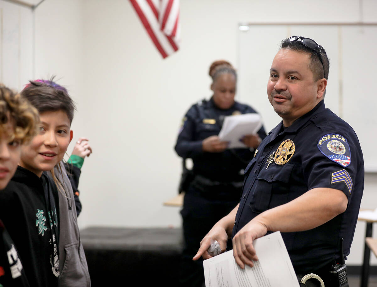 Clark County School District Police Officer Juan Wibowo addresses students in a class for the L ...