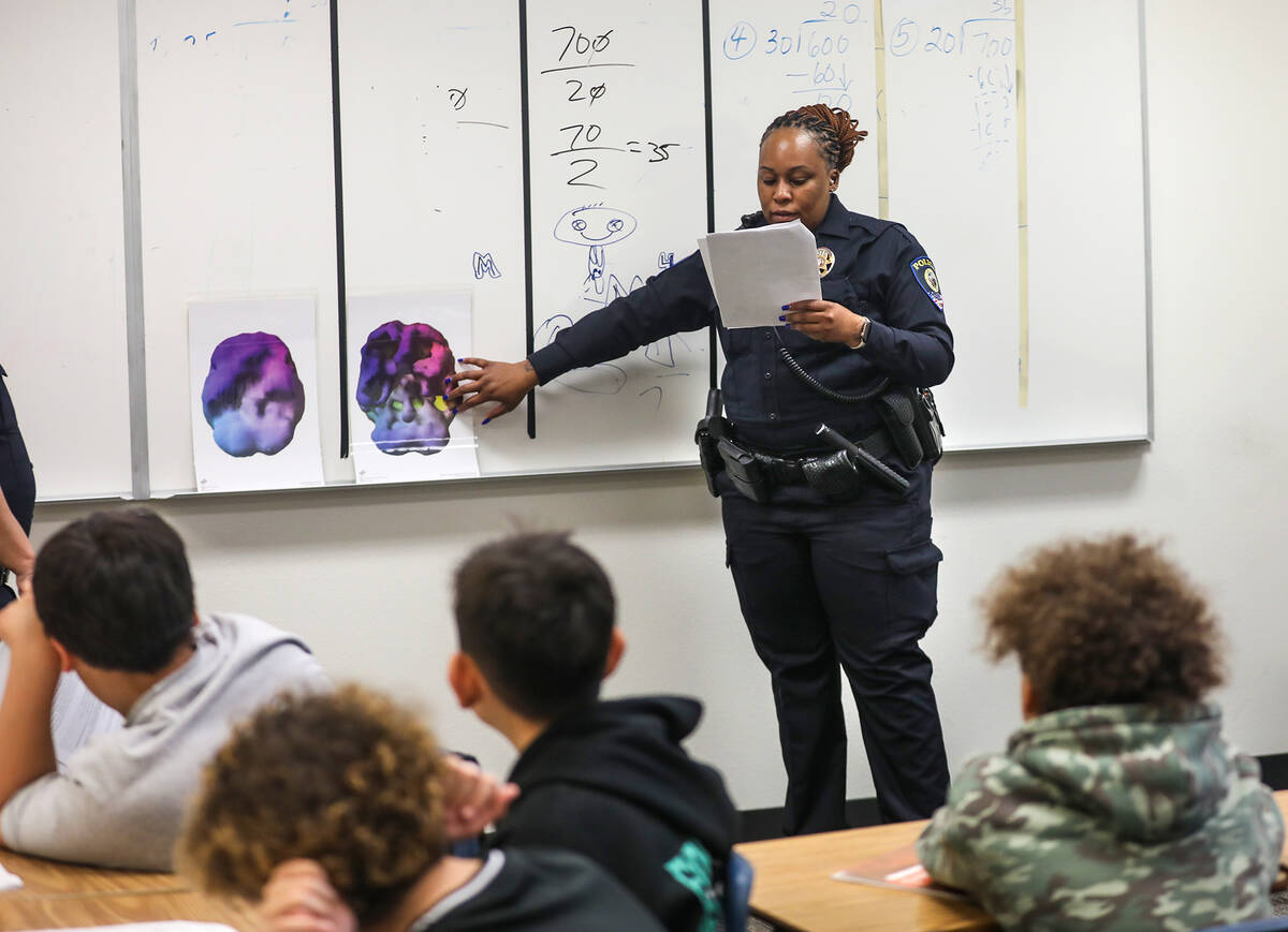 Clark County School District Police Officer Artesia Henry addresses students about the effects ...