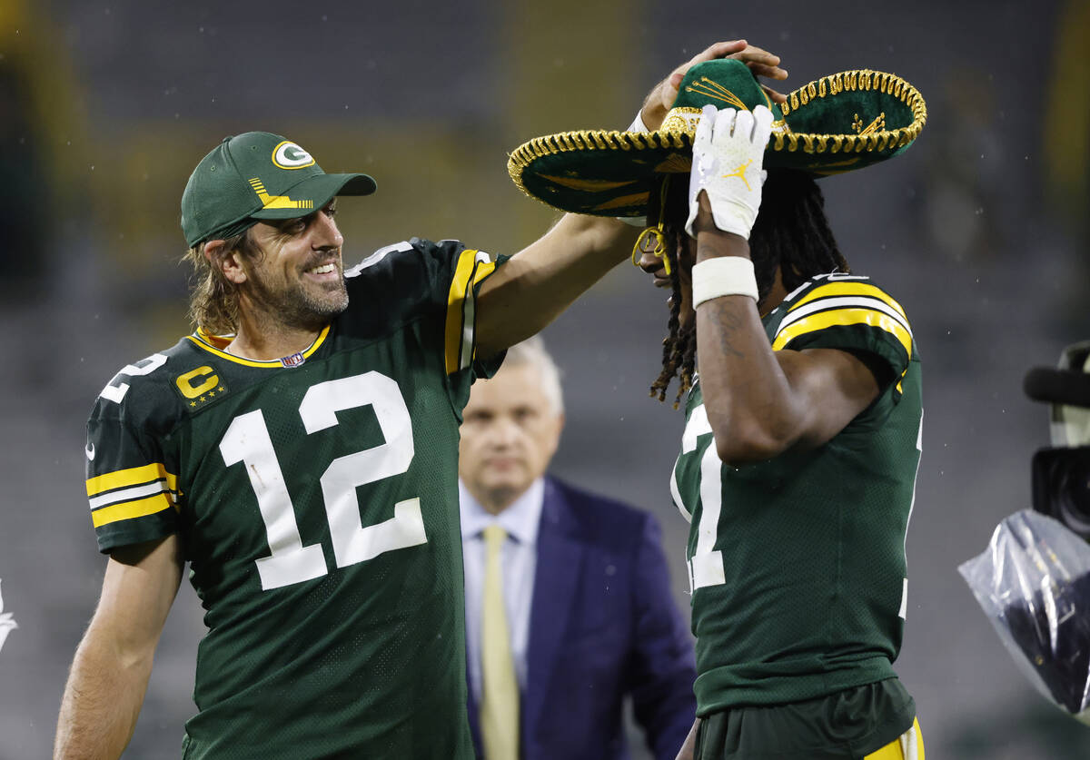 Green Bay Packers quarterback Aaron Rodgers (12) puts on a sombrero on teammate Green Bay Packe ...
