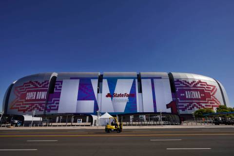Workers prepare for the NFL Super Bowl LVII football game outside State Farm Stadium, Thursday, ...