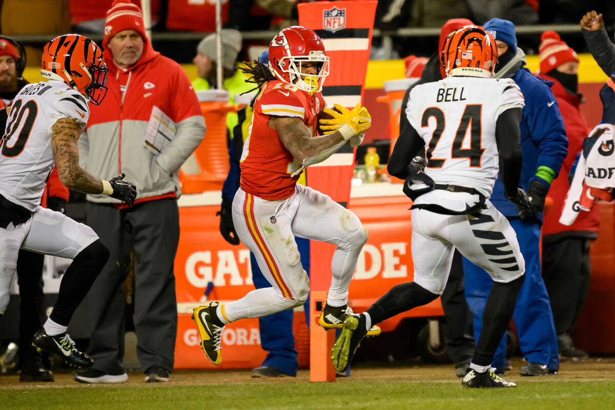 Kansas City Chiefs running back Isiah Pacheco (10) runs for a first down while being chased by ...