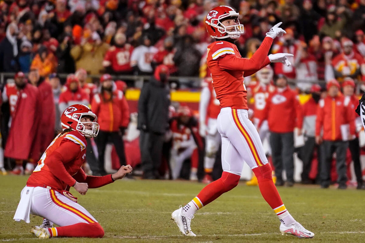 Kansas City Chiefs place kicker Harrison Butker, right, watches his game-winning field goal aga ...