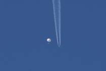 In this photo provided by Brian Branch, a large balloon drifts above the Kingstown, N.C. area, ...