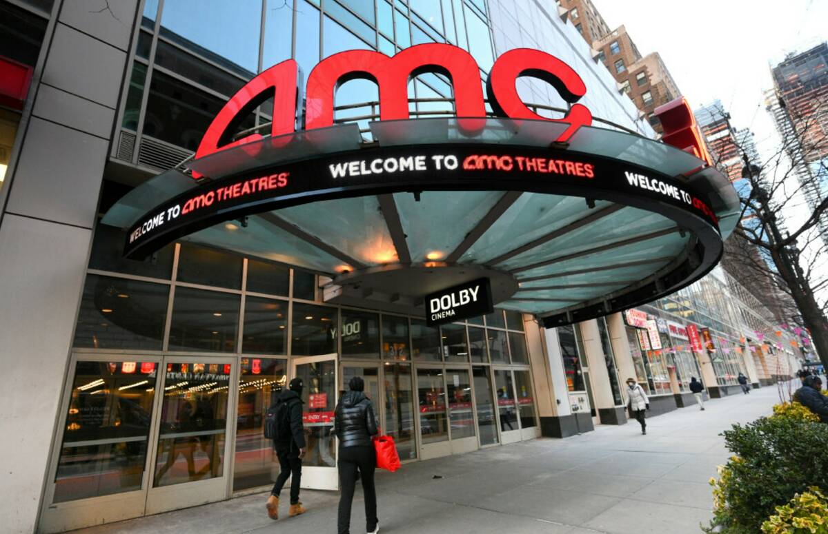 People walk by the AMC 34th Street theater on March 5, 2021, in New York. (Photo by Evan Agosti ...
