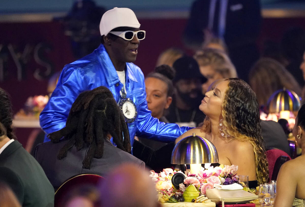 Flavor Flav, left, speaks with Beyonce in the audience at the 65th annual Grammy Awards on Sund ...