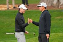 Gareth Bale, left, is greeted by Joseph Bramlett after putting on the third green of the Pebble ...