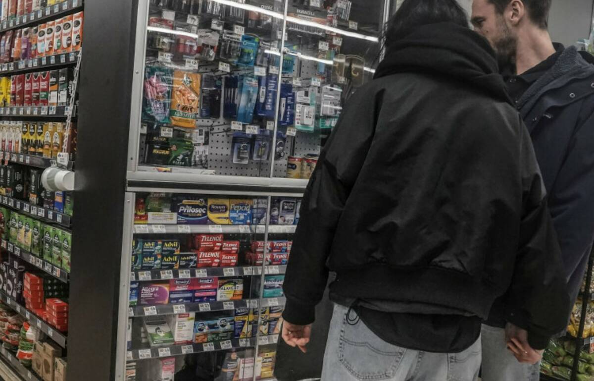 Shoppers browse pharmaceutical items locked in a glass cabinet at a Gristedes supermarket, Tues ...