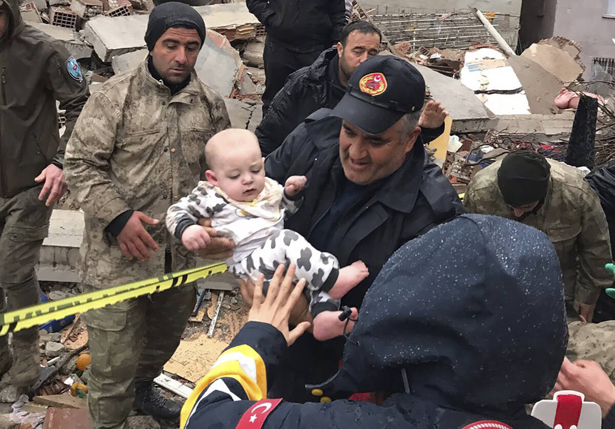 A baby is rescued from a destroyed building in Malatya, Turkey, Monday, Feb. 6, 2023. A powerfu ...