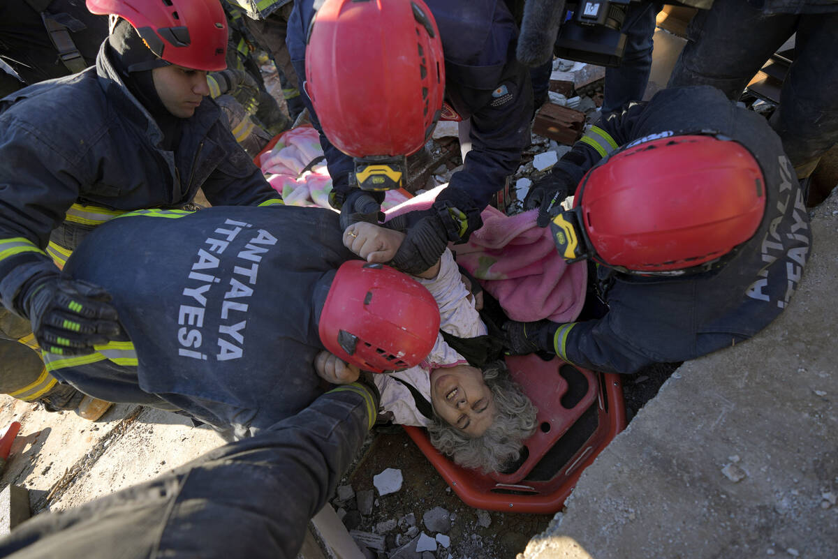 Rescue teams evacuate a survivor from the rubble of a destroyed building in Kahramanmaras, sout ...