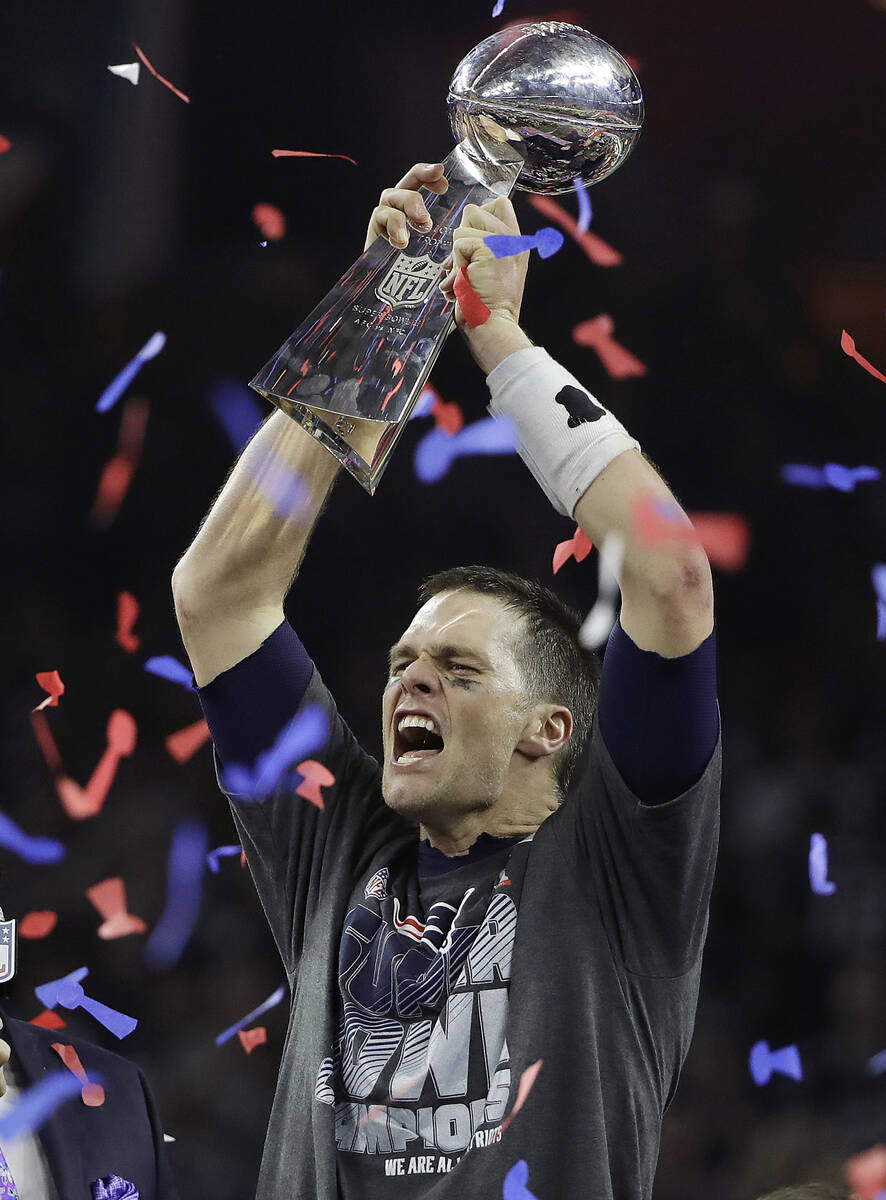 New England Patriots quarterback Tom Brady celebrates with the Vince Lombardi Trophy after the ...