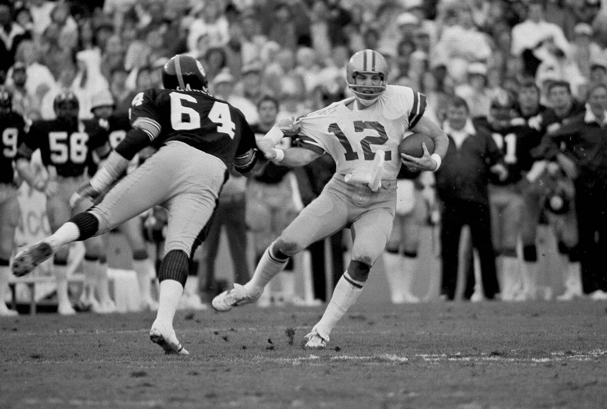 Dallas Cowboys quarterback Roger Staubach is caught by Pittsburgh Steelers Steve Furness during ...