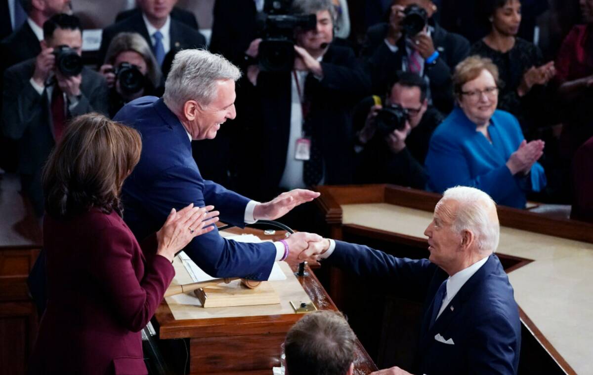 President Joe Biden arrives and shakes hands with House Speaker Kevin McCarthy of Calif., befor ...