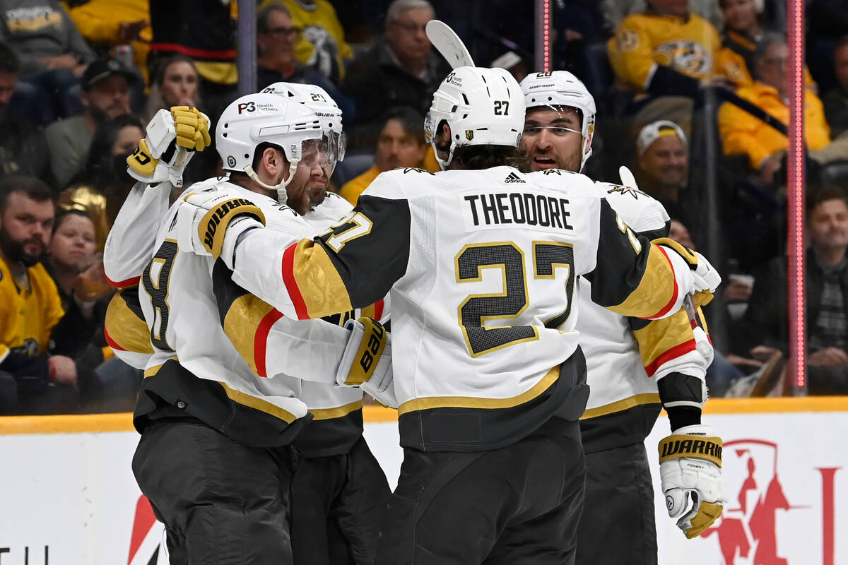 Vegas Golden Knights right wing Phil Kessel, left, celebrates with teammates after scoring a go ...