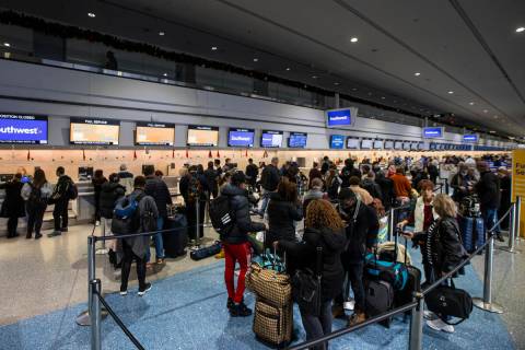 Passengers line up to check-in at Southwest Airlines at Harry Reid International Airport on Thu ...