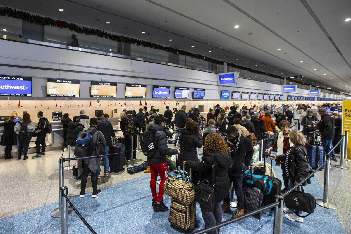 Passengers line up to check-in at Southwest Airlines at Harry Reid International Airport on Thu ...