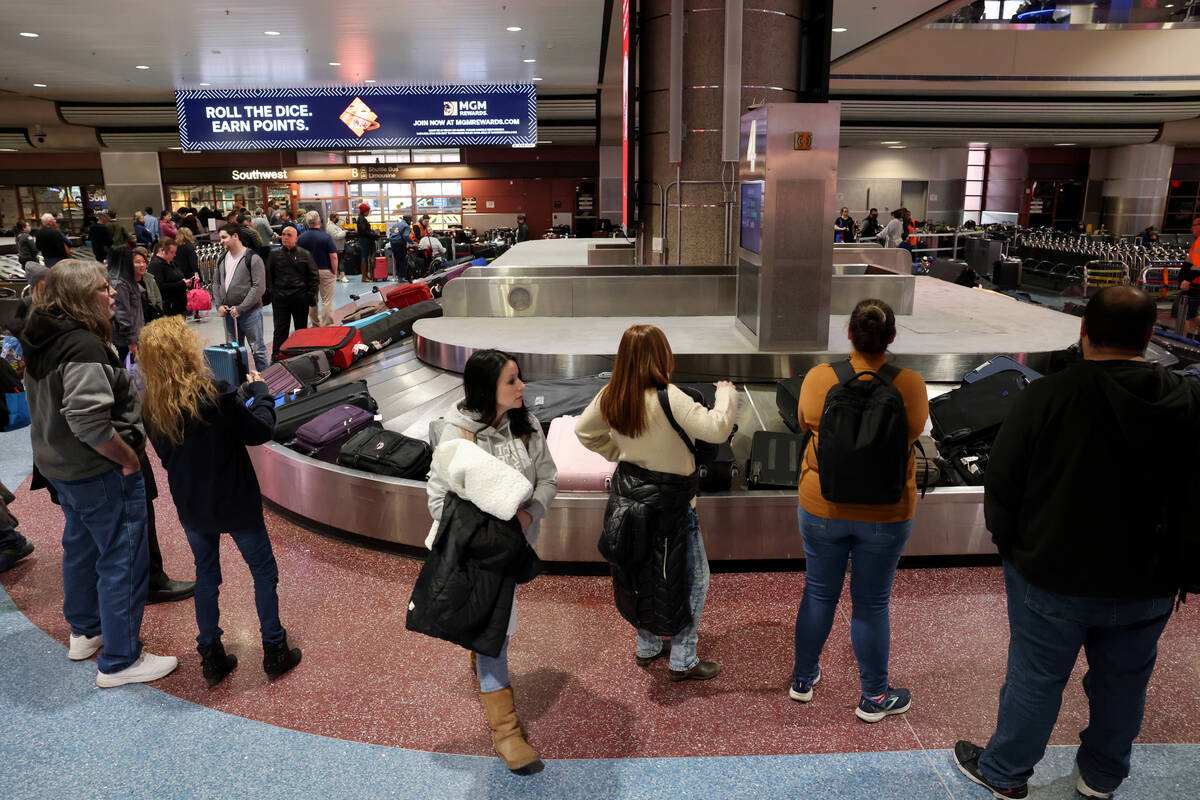 Passengers wait to retrieve their luggage from cancelled and delayed flights in the Southwest b ...