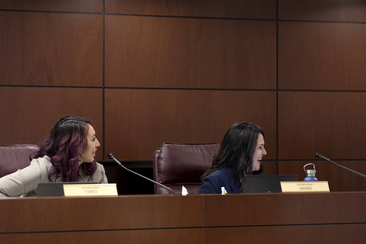 Assemblywomen Selena Torres, D-Las Vegas, and Alexis Hansen, R-Sparks, laugh with fellow lawmak ...