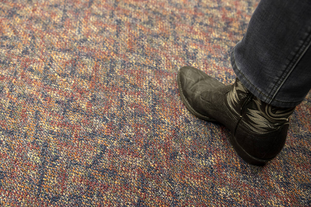 An attendee of a meeting of the Assembly Committee on Education wears cowboy boots during the 8 ...