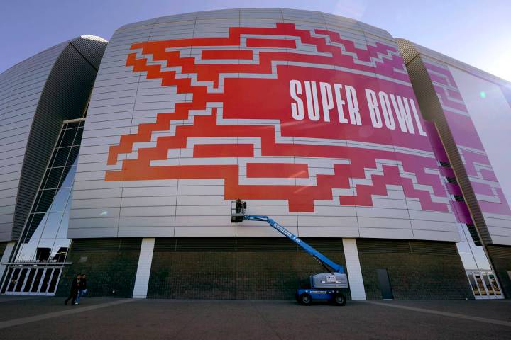 Workers prepare for the NFL Super Bowl LVII outside State Farm Stadium, Wednesday, Feb. 1, 2023 ...