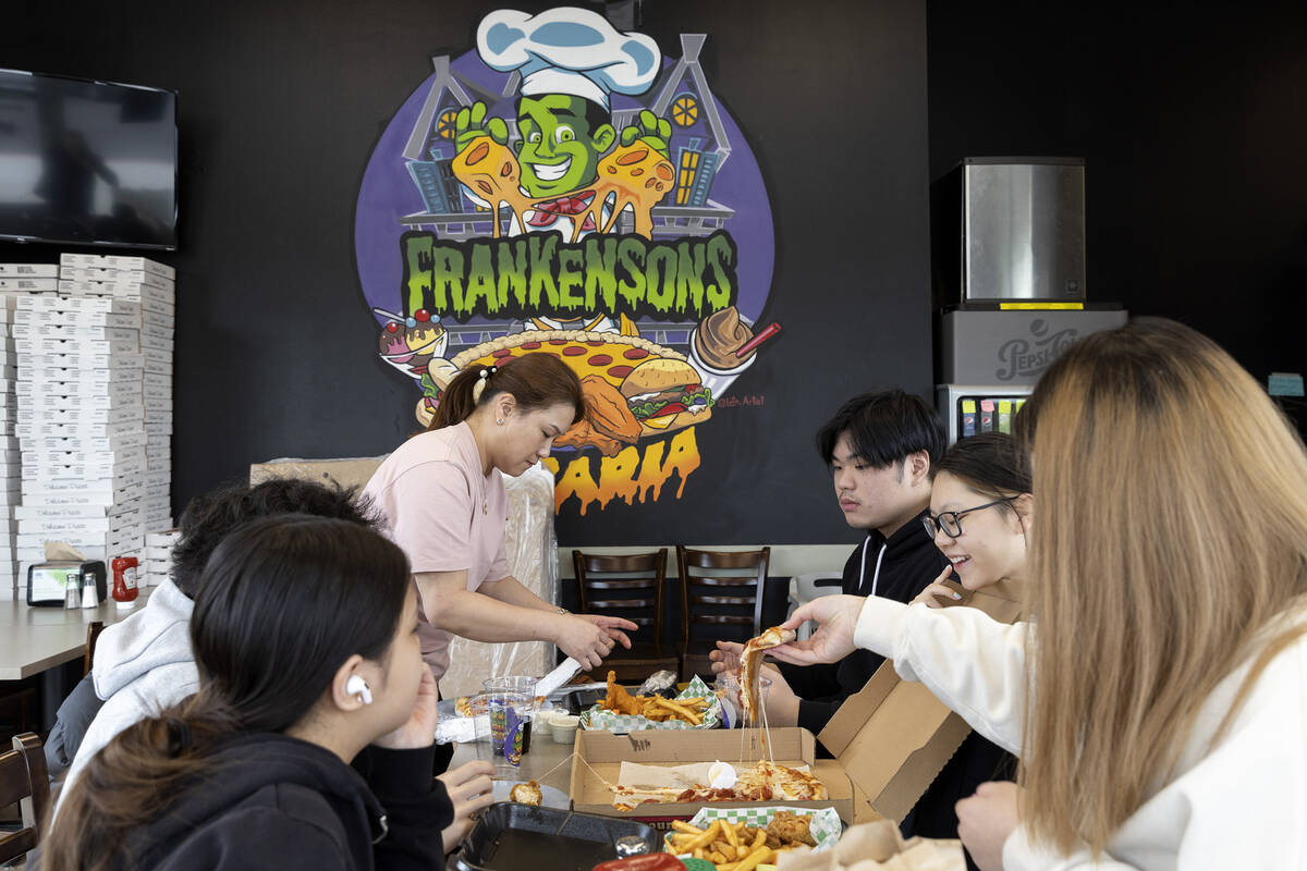 The Liu family, of Queens, New York, eat pizza and wings at Frankensons pizzeria on Friday, Feb ...