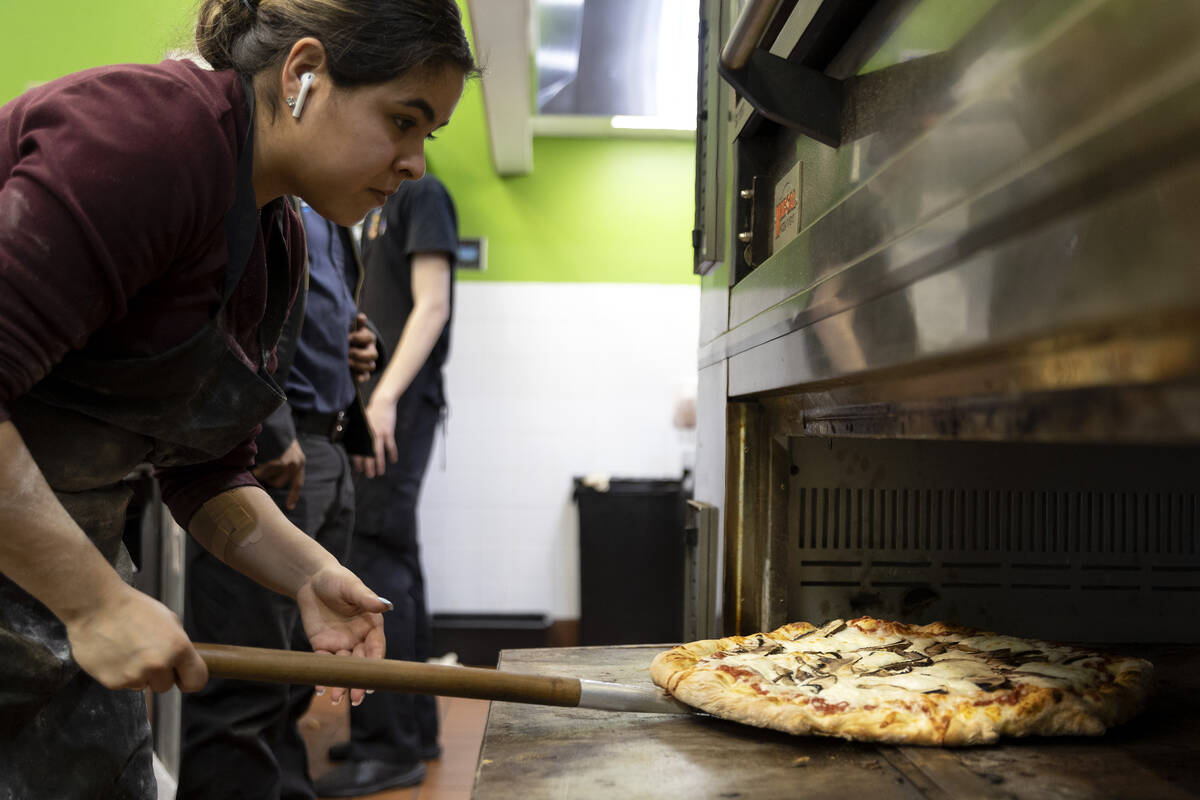 Pizza maker Sofia Terrazas finishes a mushroom pizza at Frankensons pizzeria on Friday, Feb. 24 ...