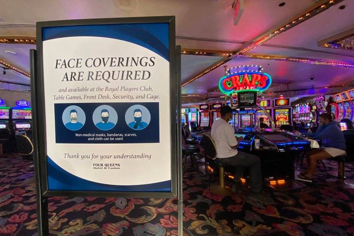 A sign notifying guests of face covering requirement at Four Queens in downtown Las Vegas Frida ...