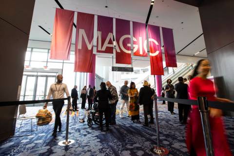 Visitors walk into an exhibit hall during the MAGIC Las Vegas fashion trade show on Monday, Aug ...