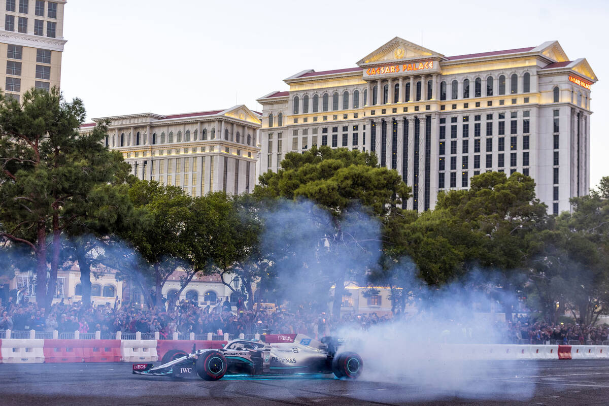 Racer George Russell turns doughnuts across from the Bellagio while racing down the Strip durin ...