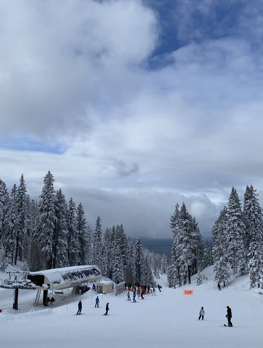 Skiers and snowboarders gather and get in line for the Crystal Express chairlift at Diamond Pea ...