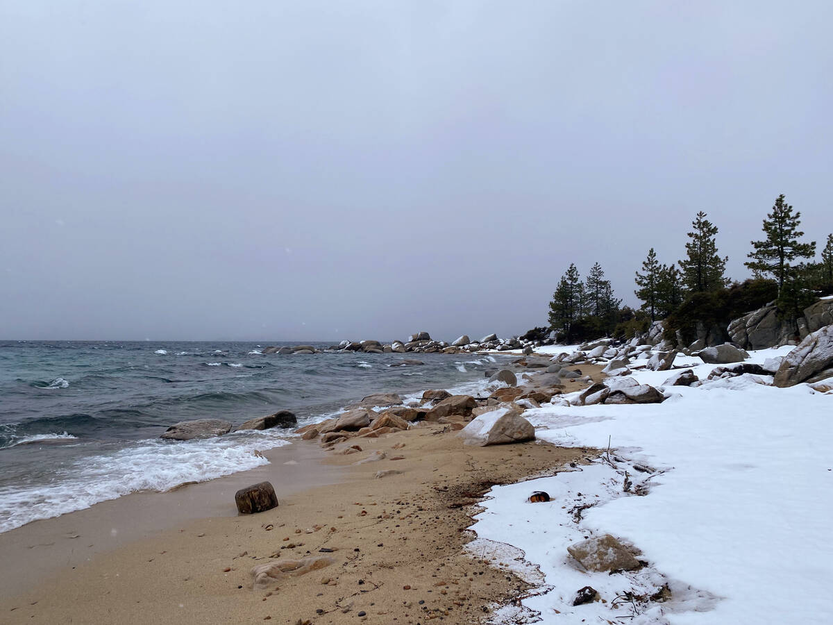 Choppy Lake Tahoe waters and a snowy shoreline in mid-January at Hidden Beach, which is accessi ...