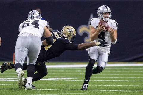 Raiders quarterback Derek Carr (4) tries to rush past New Orleans Saints defensive end Cameron ...