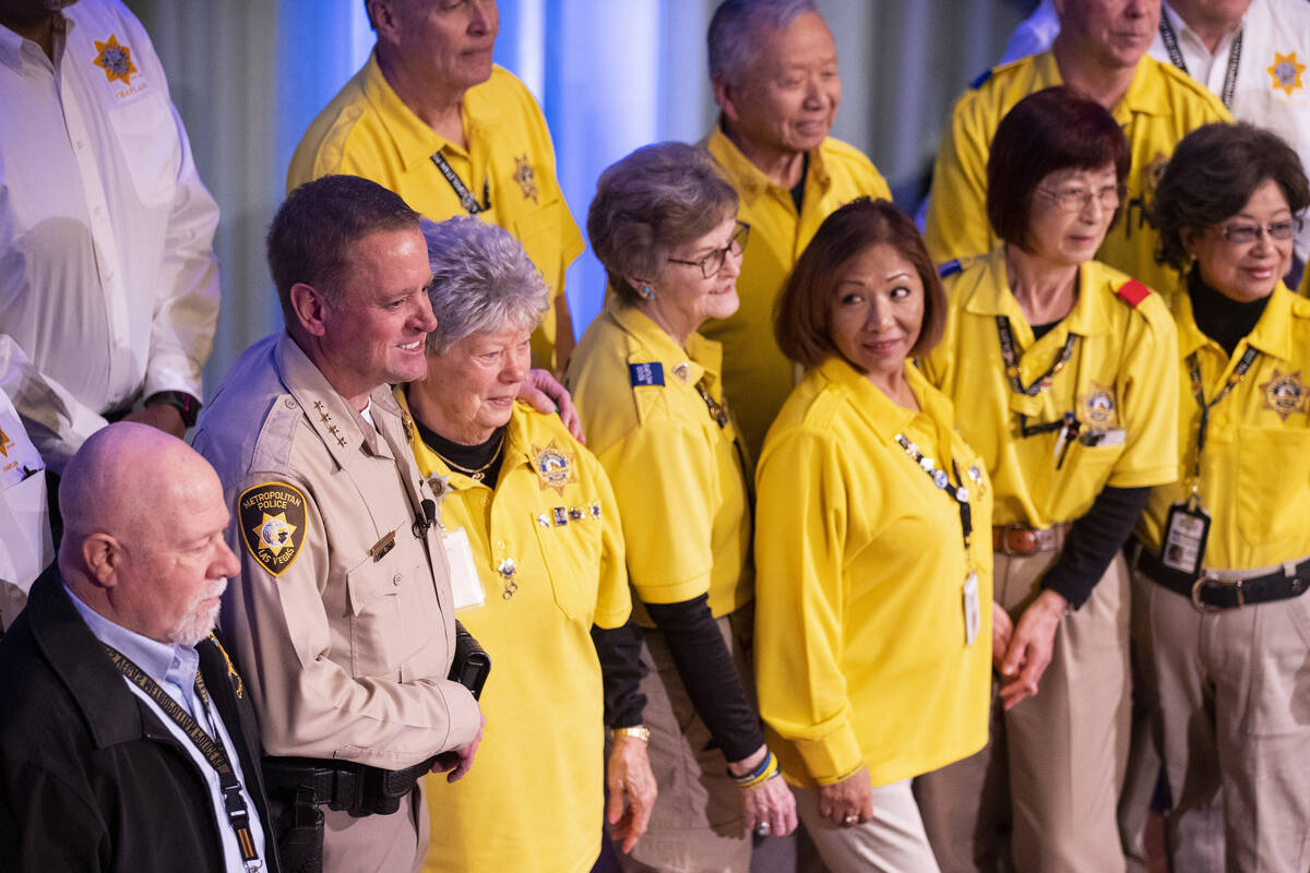Sheriff Kevin McMahill, left, poses with volunteers, after delivering the State of the Departme ...