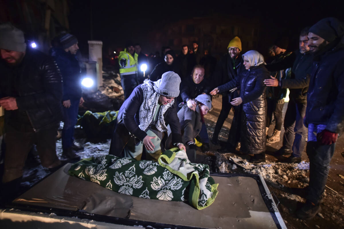 Relatives weep over the dead body of Goktug, a baby boy, in Elbistan, southern Turkey, late Tue ...