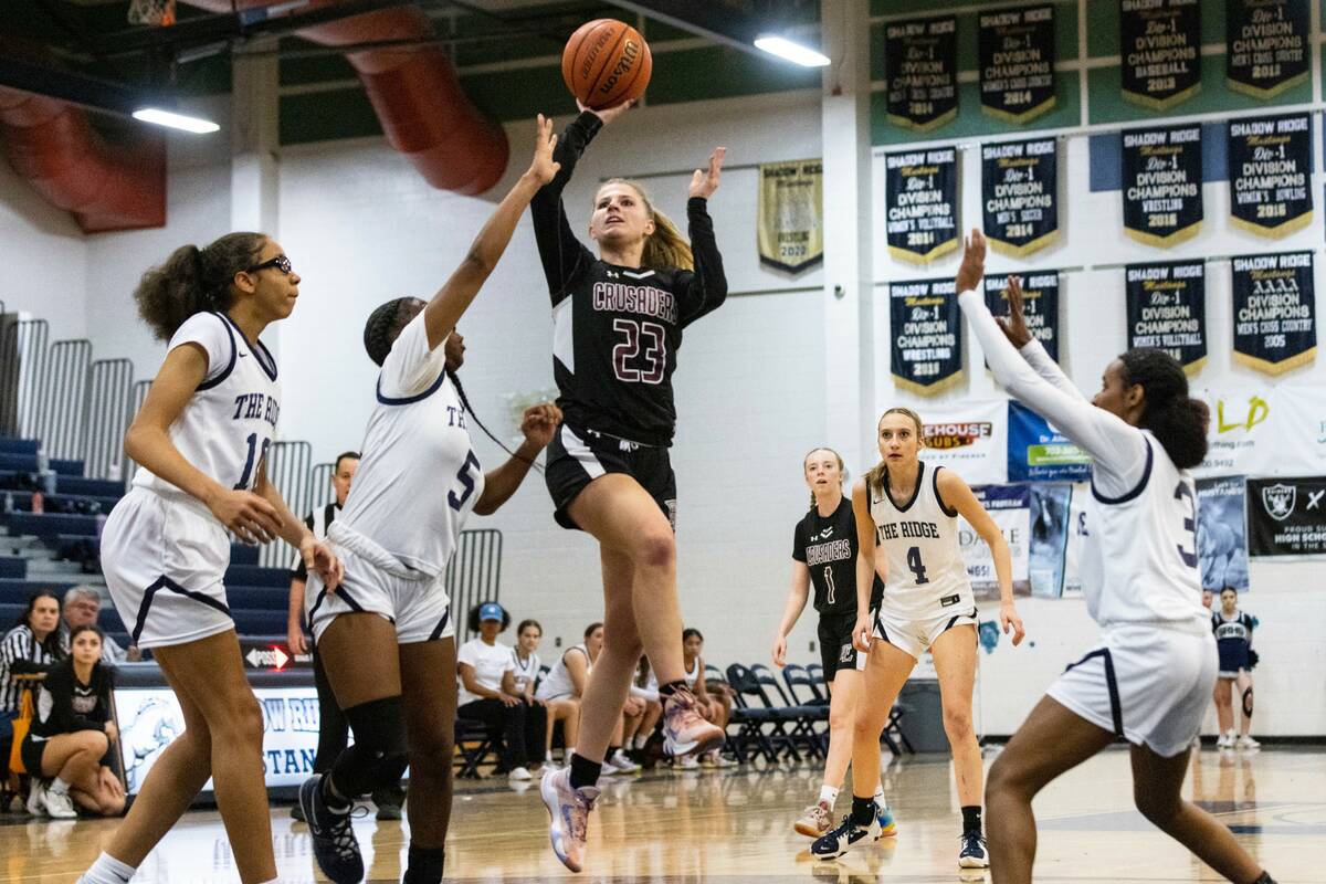 Faith Lutheran's Raina Forgue (23) shoots over Shadow Ridge's Zh'mya Martin (5) Jaslyn Jefferso ...