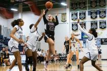 Faith Lutheran's Raina Forgue (23) shoots over Shadow Ridge's Zh'mya Martin (5) Jaslyn Jefferso ...