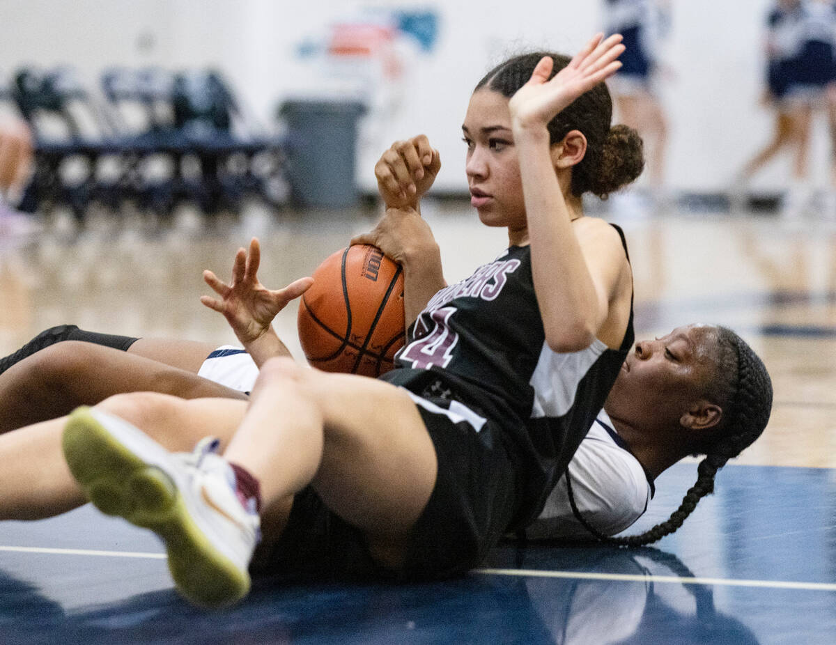 Faith Lutheran's Leah Mitchell (34) and Shadow Ridge's Zh'mya Martin (5) fight for the loose ba ...
