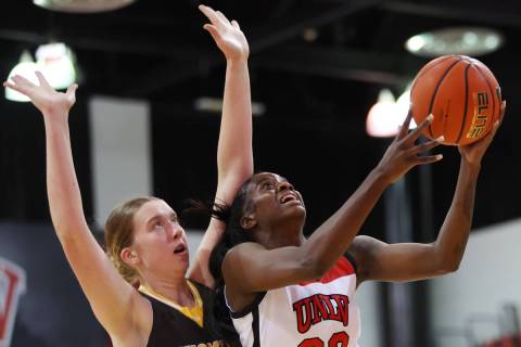 UNLV Lady Rebels center Desi-Rae Young (23) goes up for a shot under pressure from Wyoming Cowg ...