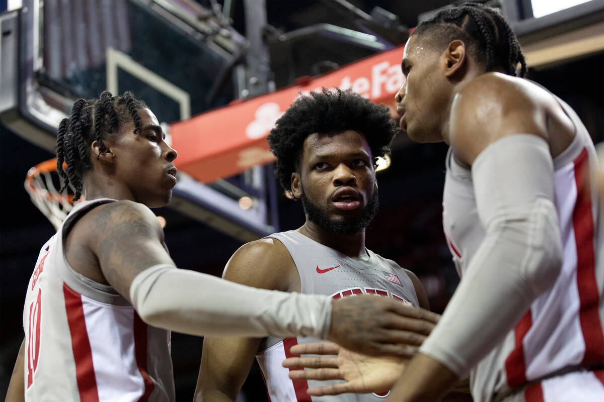 UNLV Rebels guard Keshon Gilbert (10), guard EJ Harkless, center, and guard Luis Rodriguez slap ...