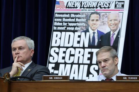 With a poster of a New York Post front page story about Hunter Biden’s emails on display ...