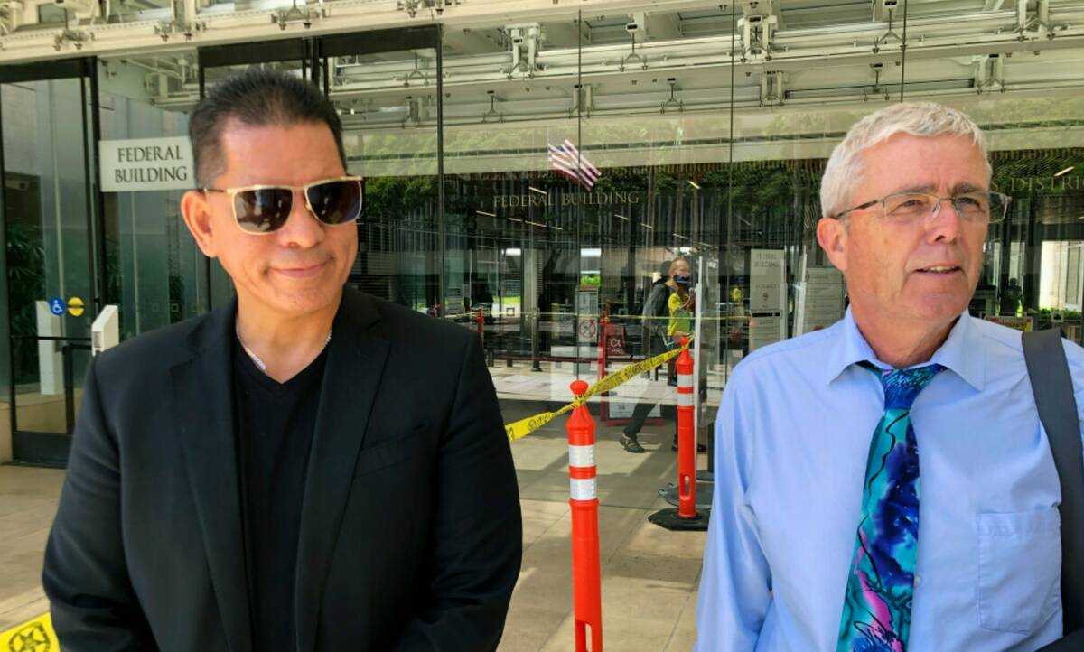 Stewart Olani Stant, left, listens while his attorney Cary Virtue speaks to reporters outside U ...